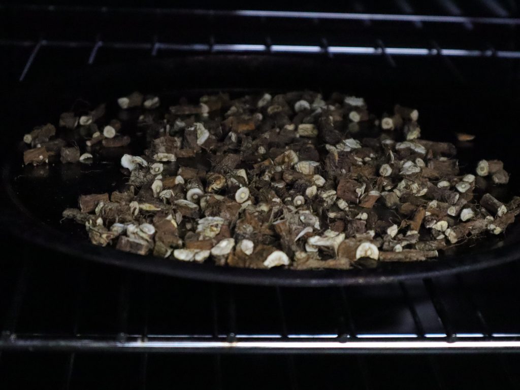 chopped roots on pan in oven for roasting