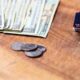 Fanned out cash and coins with wallet on counter top